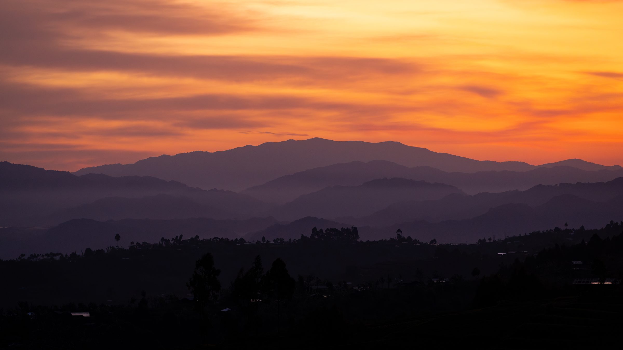 Mist over hills near the Virunga volcanoes at dusk